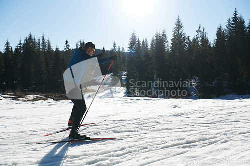 Image of Nordic skiing or Cross-country skiing classic technique practiced by man in a beautiful panoramic trail at morning.Selective focus.