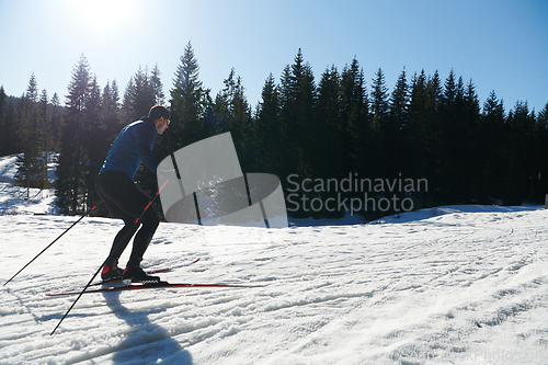 Image of Nordic skiing or Cross-country skiing classic technique practiced by man in a beautiful panoramic trail at morning.Selective focus.