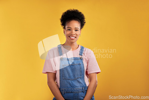 Image of Fashion, portrait and happy black woman in studio with confidence, style and cool outfit on yellow background. Face, smile and stylish African female model pose with trendy and fashionable clothes