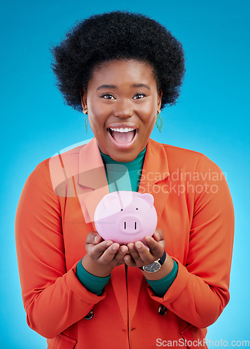 Image of Woman, piggy bank and wow portrait for savings, financial investment and profit or budget success. Excited african person with banking goals, finance safe and container on a blue, studio background