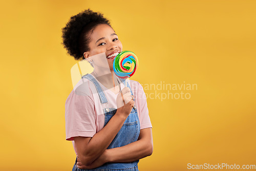 Image of Happy, candy and portrait of a black woman with a lollipop on a studio background for food. Smile, mockup and an African girl or model with sweets for dessert isolated on a backdrop with space