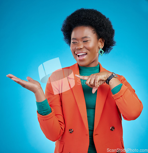 Image of Hand, presentation and business woman with offer, choice and information for fashion, sale or opportunity. Happy african person or model pointing to palm, decision or design on blue studio background