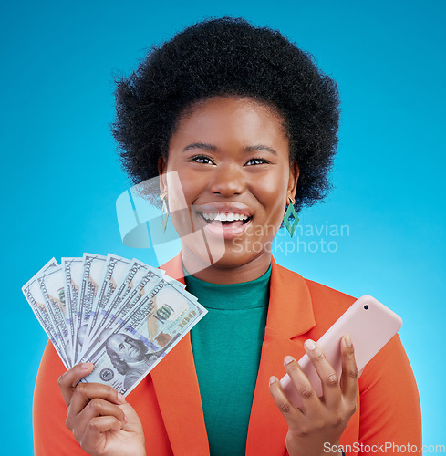 Image of Black woman, money fan and phone in studio portrait with wow, surprise or happy for profit by blue background. African gen z girl, smartphone and cash with smile, winner or gambling app for giveaway