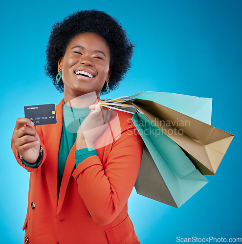 Image of Woman, credit card and shopping bag for retail banking, finance and e commerce fintech or payment in portrait. Happy customer, fashion model or african person offer or debit on blue studio background