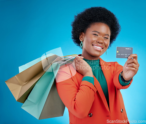 Image of Credit card, shopping offer and woman in portrait for retail banking, finance and e commerce fintech or payment. Customer face, fashion model or african person, bag and debt on blue studio background