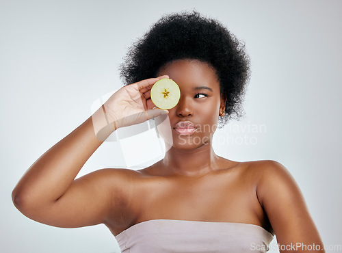 Image of Black woman, apple and afro for diet, natural nutrition or health against a white studio background. Face of African female person or model with organic fruit for fiber, vitamins or skincare wellness