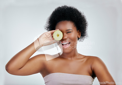 Image of Happy black woman, portrait and apple for diet, natural nutrition or health against a white studio background. Face of African female person smile with organic fruit for fiber, vitamins or body care