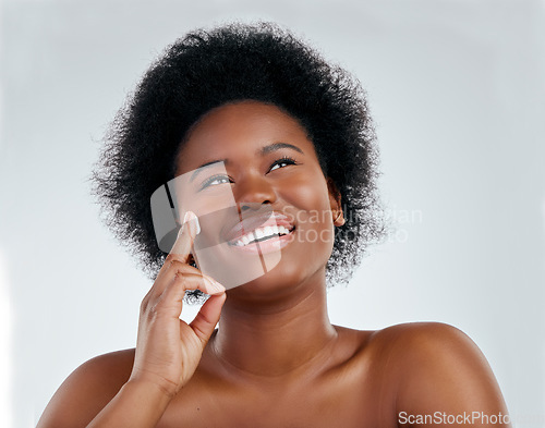 Image of Face, skincare and black woman with cream in studio isolated on white background. Application, happy and African model with moisturizer, facial cosmetic or sunscreen for dermatology, health or beauty