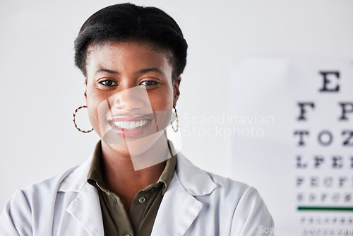 Image of Happy, optometry and portrait of a black woman at a clinic for healthcare, eye care and expert. Smile, hospital and headshot of an African doctor or optometrist in an office for a vision check