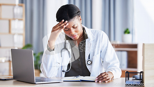 Image of Doctor, African woman and headache with laptop at desk, clinic office or stress with thinking at job. Overworked medic, fatigue and burnout in hospital, book or anxiety for mental health by computer