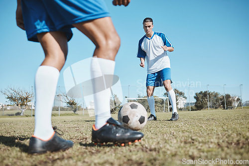 Image of Football player, ball and game on field for team competition, game or match training, exercise and strategy. Goal, action and young people or men with soccer or legs cardio on sports pitch or ground