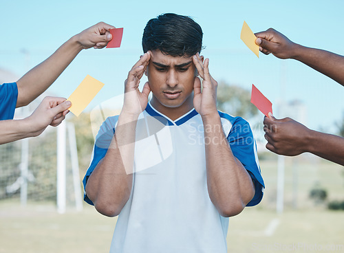 Image of Hands, card and a man with headache from soccer, fitness stress and warning on the field. Sports, burnout and a frustrated athlete with anxiety during a football game with a referee fail or problem