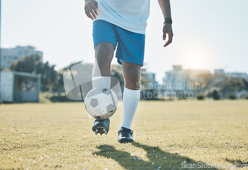 Image of Training, field and legs of a man with a football for a game, fitness and learning sports. Grass, workout and feet of an athlete for a goal, exercise and playing professional soccer in nature