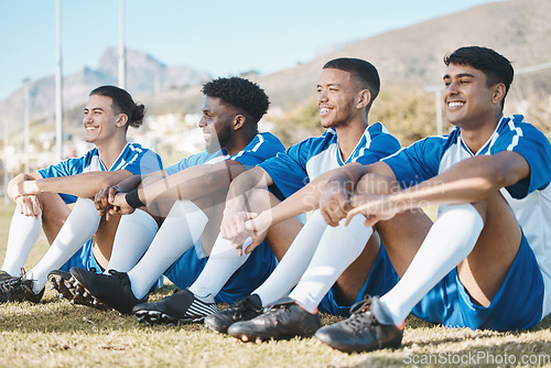 Image of Happy soccer players, relax or team on a field for a sports game together in summer on resting break. Smile, stadium or group of football athletes sitting after fitness exercise, training or match