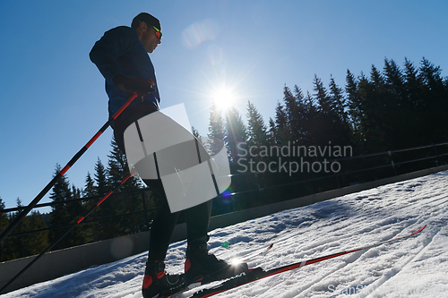 Image of Nordic skiing or Cross-country skiing classic technique practiced by man in a beautiful panoramic trail at morning.Selective focus.