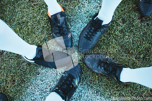 Image of Soccer, sport shoes and teamwork with people together on a grass field for motivation or competition. Closeup, above and football player or athlete group on a pitch for training, exercise or fitness