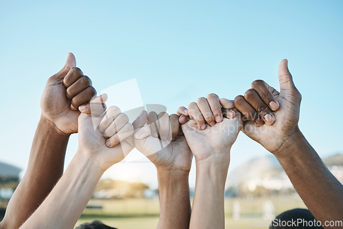 Image of Fist, hands and group with diversity for outdoor celebration or team building together for support, motivation and solidarity. Hand, ready for sport or teamwork with community of people on blue sky