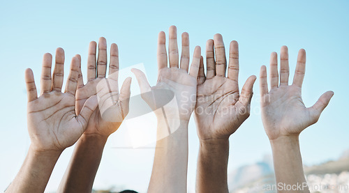 Image of Diversity, palm of hands and group for outdoor celebration or team building together for support, motivation and solidarity. Raised hand, question or community of people on blue sky background