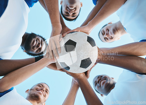 Image of Soccer ball, support or team in a huddle for motivation, goals or group mission for a sports game or match. Smile, sky or low angle of happy football players in exercise, workout or fitness training