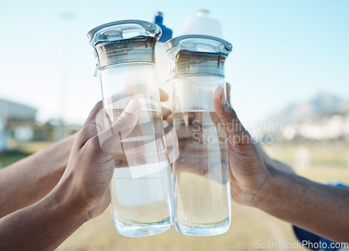 Image of Fitness, water bottle or hands toast in stadium together after workout, exercise or training game outdoors. Sports target, cheers or closeup of team with liquid for hydration in celebration of goals