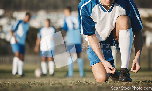 Image of Tie, man or soccer player with shoes on football field in training, exercise or workout in Brazil. Lace, stadium or hands of athlete ready to start fitness match or sports game with boots or footwear