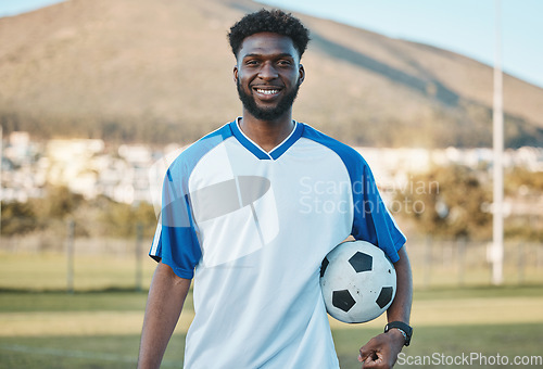 Image of Soccer ball, football player or portrait of black man with smile in sports training, game or match on pitch. Happy, fitness or proud African athlete in practice, exercise or workout on grass field