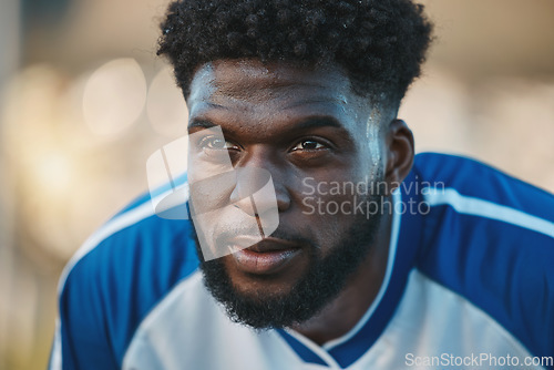 Image of Soccer player, thinking or tired black man in sports training, game or match breathing on a field pitch. Face, fatigue or exhausted African athlete in football workout or fitness exercise on break