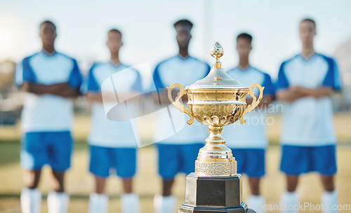 Image of Soccer team, trophy and sports tournament for winning challenge, teamwork or event on the field outdoors. Gold award, championship or prize with group standing ready in football competition or league