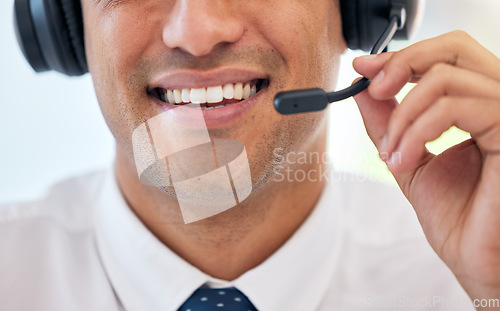 Image of Happy man, smile and headphones with mic in call center for customer service, support or telemarketing at office. Closeup of male person, consultant or agent mouth for friendly online advice or help