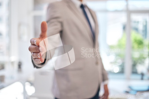 Image of Closeup of a businessman stretching for a handshake in the office for partnership, greeting or agreement. Success, welcome and zoom of professional male person with shaking hands gesture for welcome.