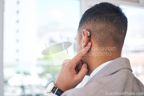 Image of Back, business man and hearing aid for ear, sound amplifier and audio communication in company office. Professional, person with a disability and deaf with implant technology to help with listening