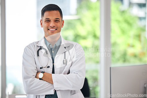 Image of Smile, portrait of man and doctor with arms crossed in hospital or clinic. Face, medical professional or confident surgeon, happy expert or employee from Brazil ready for healthcare, wellness or work