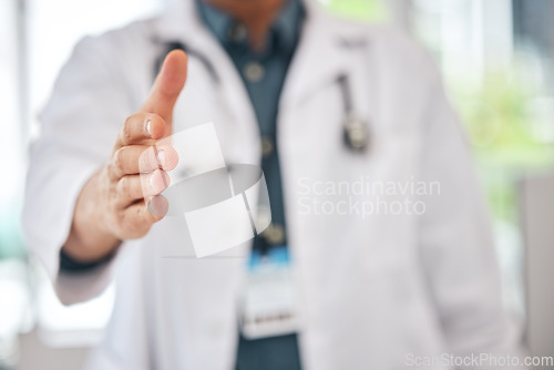 Image of Handshake, offer and doctor introduction, thank you and healthcare deal, success or welcome to consultation. Medical professional or person shaking hands in patient POV for clinic support in closeup