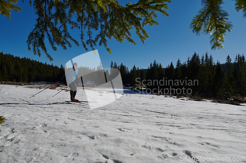 Image of Nordic skiing or Cross-country skiing classic technique practiced by man in a beautiful panoramic trail at morning.Selective focus.