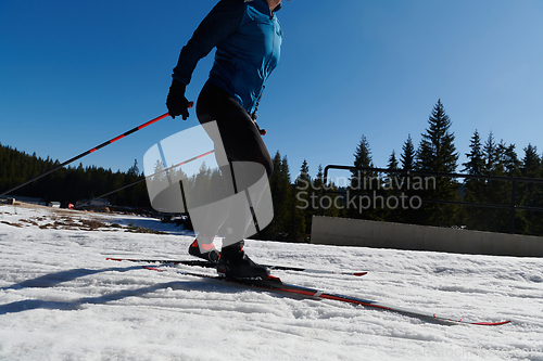 Image of Nordic skiing or Cross-country skiing classic technique practiced by man in a beautiful panoramic trail at morning.Selective focus.