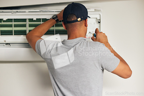 Image of Maintenance, air conditioner and man with screwdriver for problem solving on machine from back. Aircon, ac repair and handyman service with technician, electrician or contractor work on ventilation.