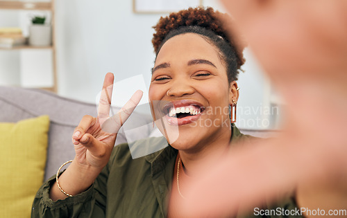 Image of Portrait, happy black woman and peace for selfie in home, online live streaming and influencer. Face of female gen z smile for profile picture, v sign and hand emoji for memory of social media post