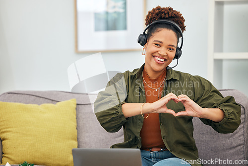 Image of Heart in hands, customer service and portrait of black woman on sofa for remote work, business and startup. Working from home, emoji and female person with hand sign for love, care and crm support