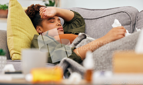 Image of Sick, pills and black woman on sofa with tissue paper, flu and headache from viral infection in her home. Bacteria, migraine and African lady with virus, fatigue and nausea medicine in living room