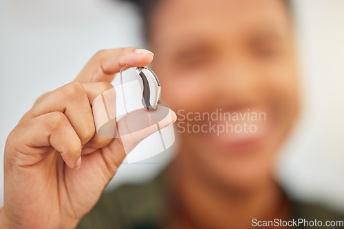 Image of Hearing aid, hands and person with disability for medical support, listening or healthcare innovation. Closeup of deaf patient with audiology implant, amplifier tech or accessory to help sound waves