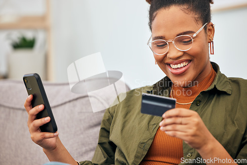 Image of Happy black woman, credit card and ecommerce with phone for digital payment, fintech account and web finance at home. Female person smile for mobile banking, online shopping and budget on technology