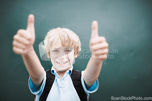 Image of Awesome. A young schoolboy giving you a thumbs up while standing alongside copyspace at a blackboard.