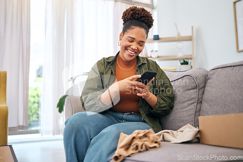 Image of Online shopping, delivery and black woman with phone on sofa happy with package or product at home. Ecommerce, smile and African lady with smartphone for customer experience, survey or app in house