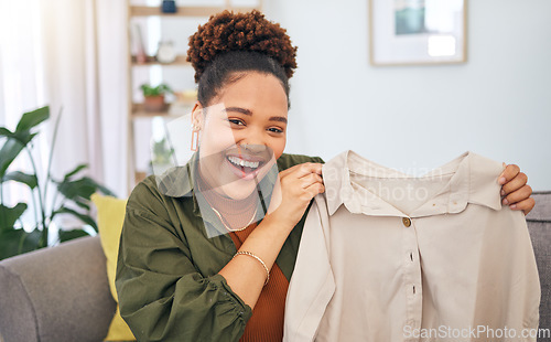 Image of Fashion, influencer and a black woman streamer unboxing a clothes outfit in her home. Social media, brand deal and a happy female content creator recording a live broadcast for subscription service
