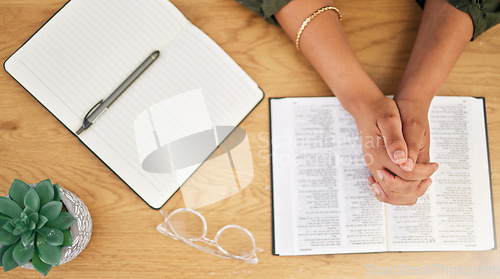 Image of Woman hands, bible and prayer in top view of spiritual faith, holy gospel and trust to worship God. Closeup of person praying with christian books, studying religion or reading praise to jesus christ