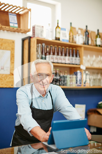 Image of Living the small business dream. Shot of a senior man working in a coffee shop.