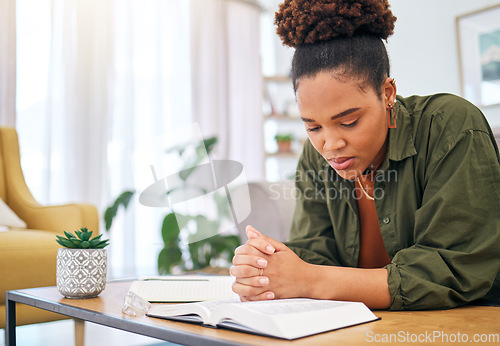 Image of Young woman, bible and prayer in home, desk and mindfulness for faith, religion and reading with hope for future. African lady, praying hands and study holy book for peace, meditation or worship God