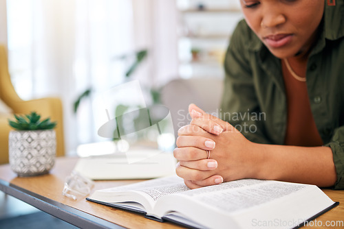 Image of Woman, bible and prayer in home, desk and mindfulness for faith, religion and reading with hope for future. African lady, praying hands and study holy book for peace, mental health or worship to God