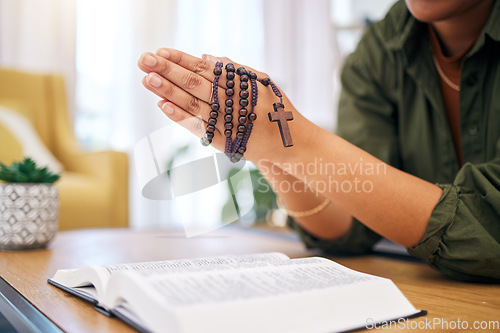 Image of Hands, bible and home for prayer, rosary and mindfulness for faith, religion or reading with hope for future. Woman, praying and study holy book with cross for peace, mental health or worship to God