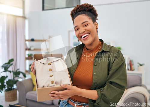 Image of Online shopping, portrait of happy woman and unboxing package, discount fashion retail and smile in living room. Delivery of clothes, ecommerce and girl in lounge with box from website sale or deal.